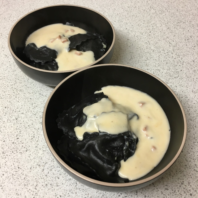 Black pasta served in bowls