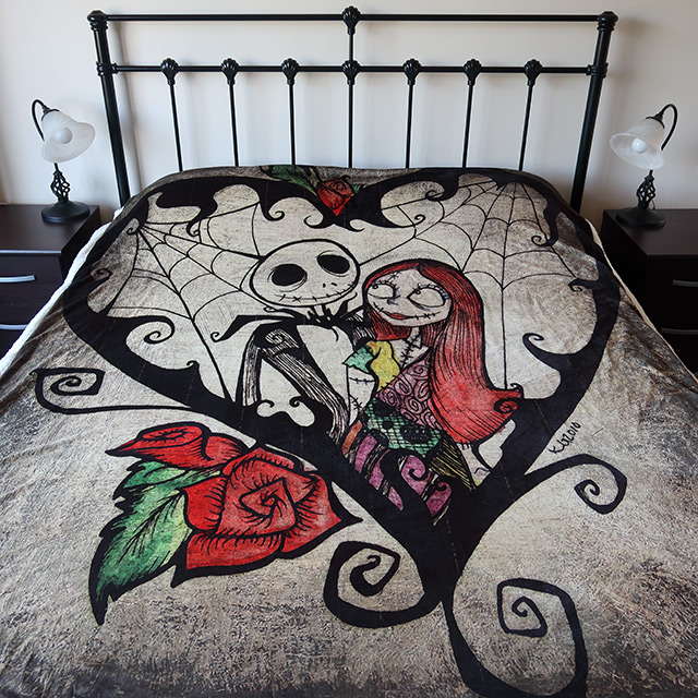 A bed with a Nightmare Before Christmas blanket