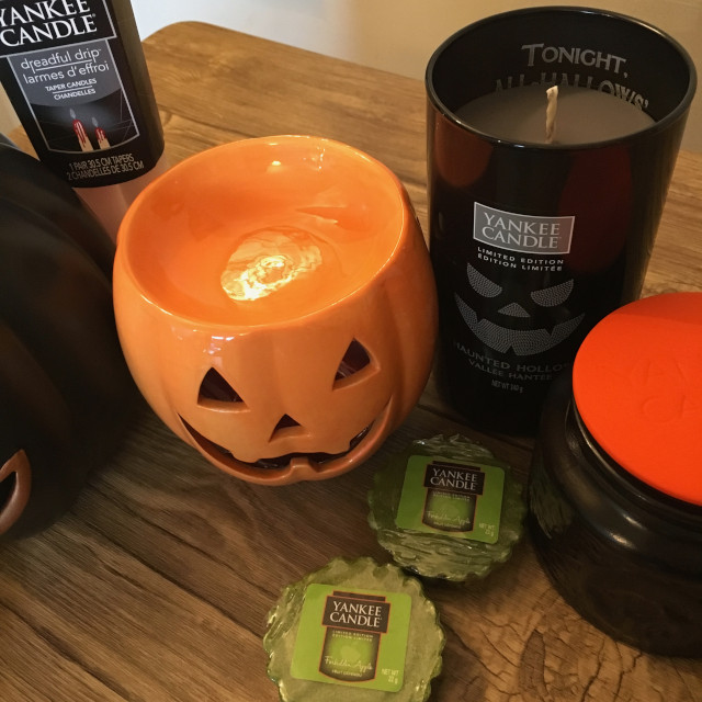 A close up of Halloween candles and a pumpkin-shaped warmer from Yankee Candle