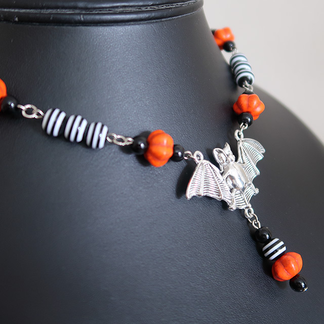 Striped bat necklace (side view)