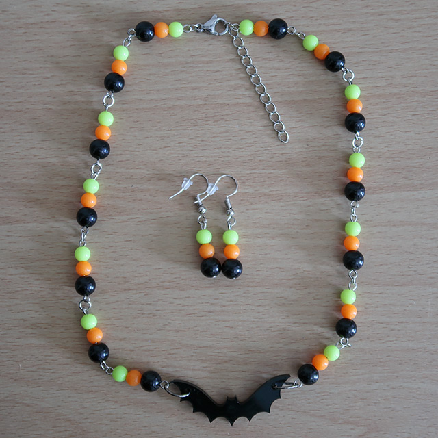 Bat necklace and earrings (overhead view, variation 3)